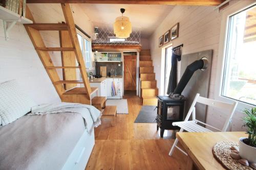 a tiny house with a staircase and a living room at Tiny house U Dlouháče in Litoměřice