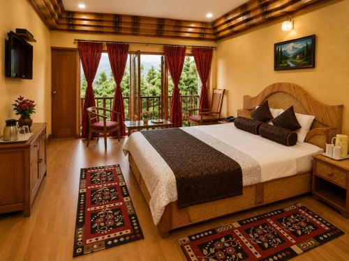 a bedroom with a bed and a balcony at Swaasha Vista in Kausani