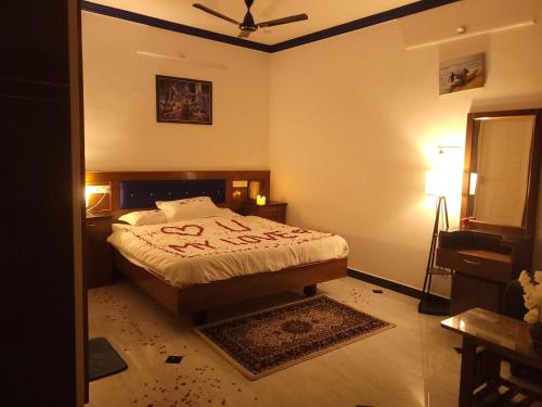 a bedroom with a bed in the corner of a room at Nivaa Stays - Near JIPMER in Pondicherry