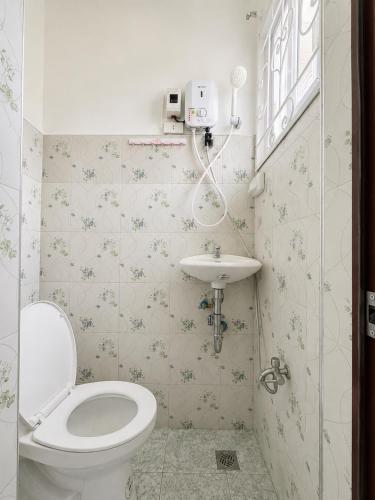 a bathroom with a toilet and a sink at Cazabela in Casisang