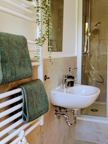 a bathroom with a sink and a shower at Gasthof Schausten in Kreuztal