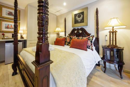 a bedroom with a large bed and two lamps at 17 On Cedar Boutique Guesthouse in Durbanville