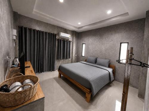 a bedroom with a bed and a basket in it at Samanta By The Hill in Ko Larn