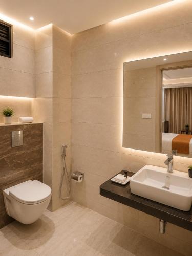 a bathroom with a toilet and a sink and a mirror at Hotel Cloud Suites Delhi Airport in New Delhi