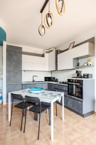 a kitchen with a table and chairs in a room at Soffio di Luce in Calderara di Reno