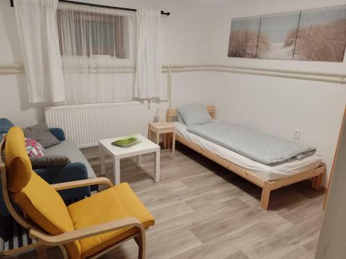 a living room with a bed and a couch at Ubytování u J & J in Lauterwasser