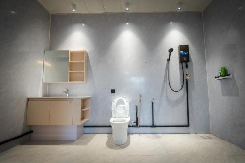 a bathroom with a shower and a toilet and a sink at Spacious 5BR Canopy Home with Farm in Kepala Batas