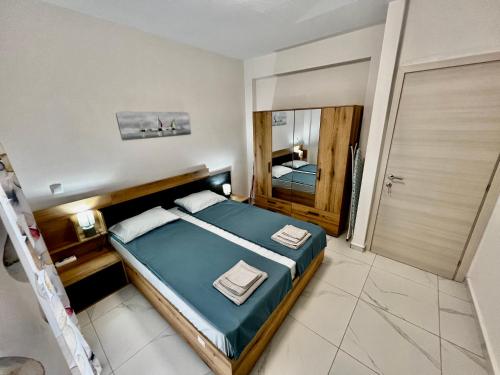 a bedroom with a bed and a mirror at BELA Apartments Kariani Near Ofrinio in Karianí