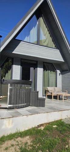 a house with a deck with a bench on it at E&T-Cabin A frame in Sibiu