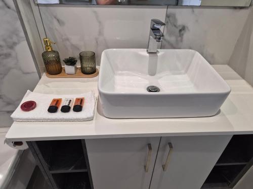 a bathroom sink with two cosmetics on a counter at 8 Guildford in George