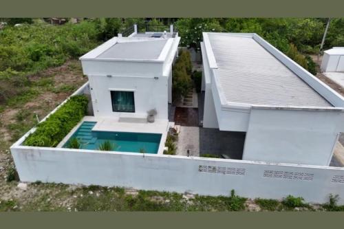 an aerial view of a house with a swimming pool at Cha-am Pool Villa in Ban Bo Prakhon