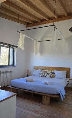 a bedroom with a large bed with blue sheets at Monte das Mariolas in Castelo de Vide
