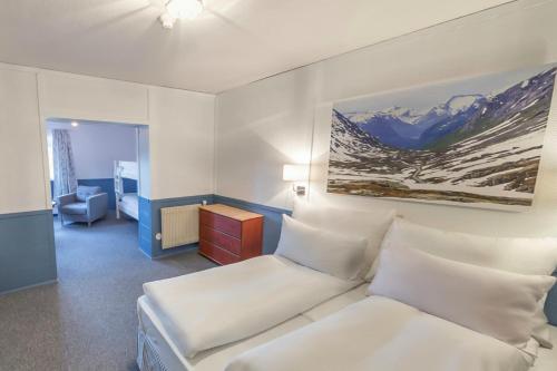 Ένα ή περισσότερα κρεβάτια σε δωμάτιο στο Rondane Høyfjellshotell