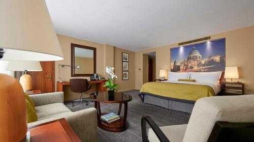 a hotel room with a bed and a living room at Threadneedles, Autograph Collection in London