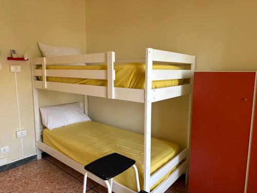 a room with two bunk beds in a room at KALEIDO Hostel in Genoa
