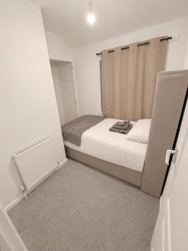 a small bedroom with a bed in a room at Newly Refurbished 3-Bed Sleeps 5 in Lostock