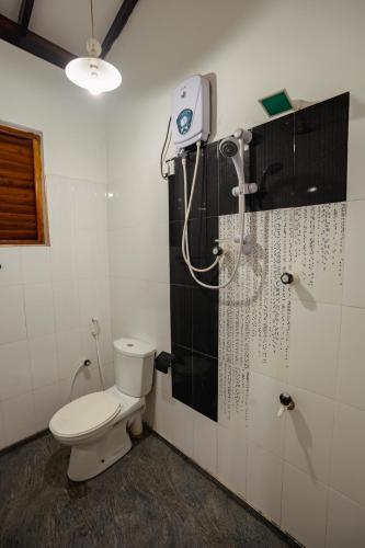 a bathroom with a toilet and a shower at Mountain Edge By Yala Odyssey in Kataragama
