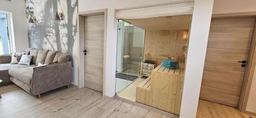 a living room with a couch and a sliding glass door at Gartenbungalow Rhönherz in Hilders