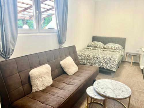 a living room with a couch and a bed at Studio Tatarskie,Parking! in Przemyśl