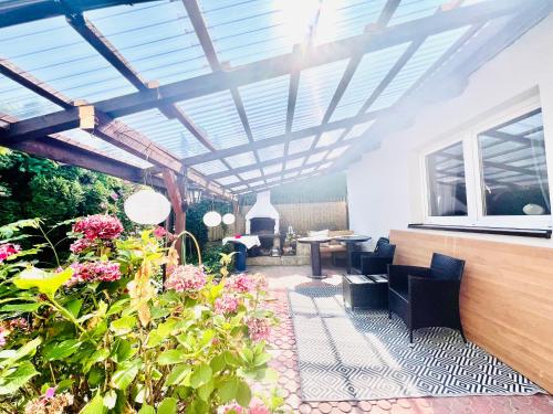 a conservatory with a pergola and some flowers at Studio Tatarskie,Parking! in Przemyśl