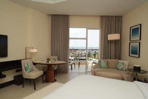 a hotel room with a bed and a living room at Lancaster Palace Tamuda Bay in Marina Smir