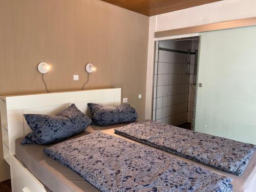 a bedroom with two beds and a mirror at promedklinik apartment 4 in Volkach