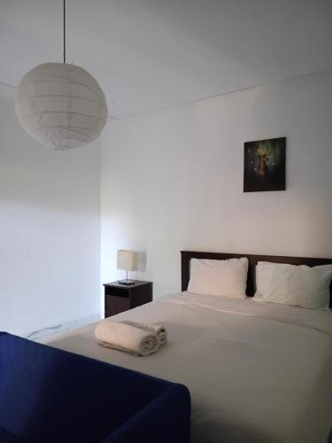 a bedroom with a large white bed with a lamp at Le Jardin Aparthotel in Taza