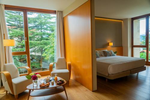 a hotel room with a bed and a table at Hotel Jaizkibel in Hondarribia