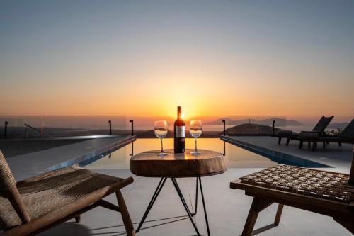 a bottle of wine and two glasses on a table on a roof at Sofia's Estates - Villa Athena -Adults Only- in Kos