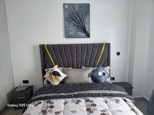 a bedroom with a bed with a large headboard at Kitusiru Falls Retreat, in Kanyongo
