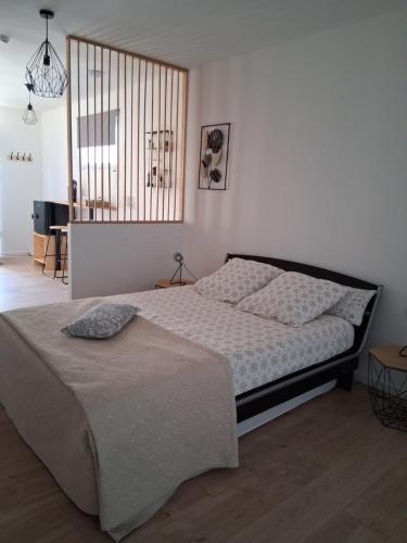 a bedroom with a large bed in a room at Beau Regard in Tournus