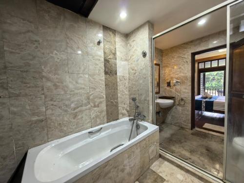 a bathroom with a bath tub and a toilet at Langkawi Lagoon Floating Resort 03 in Kampung Padang Masirat