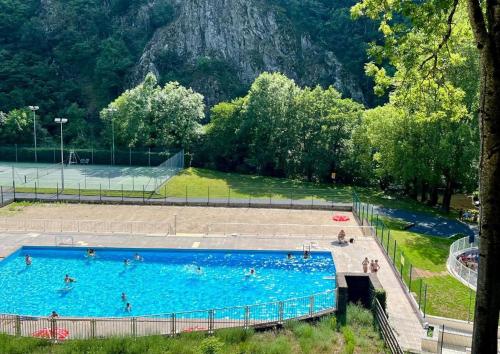 a large swimming pool with people swimming in it at Tente lodge in Brassac