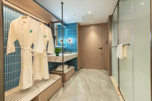 a bathroom with a robe hanging on a rack at Argyle Waifiden Hotel in Guangzhou