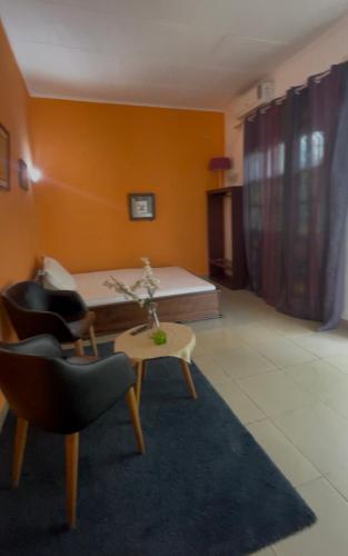 a living room with a couch and a table and chairs at Bk House in Pointe-Noire