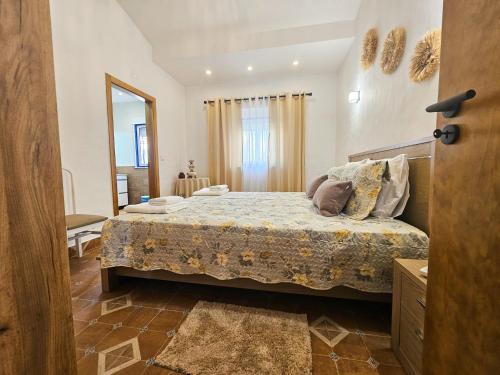 a bedroom with a large bed in a room at O Rossio in Esperança