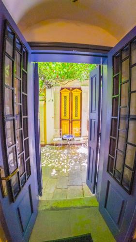 an open door leading to a courtyard with a yellow door at Kali Strata 1 - Downtown in Symi