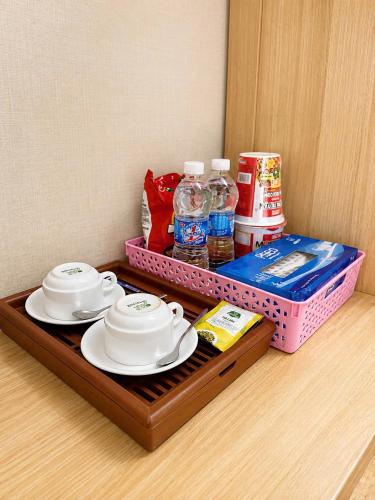 a tray with two plates and bottles of water and drinks at Khách Sạn The Second in Thốt Nốt
