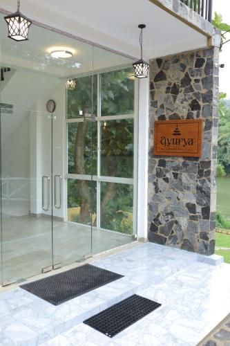 a glass shower in front of a building at Ayurya Wellness Retreat in Kandy