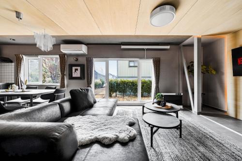 a living room with a couch and a table at The Lavenridge in Nakafurano