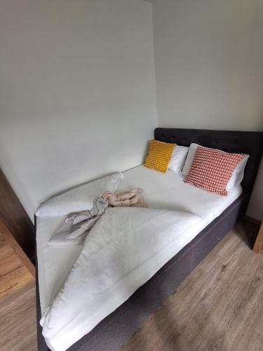 a bed with a black frame with a bow on it at Green Studio Martin in Martin