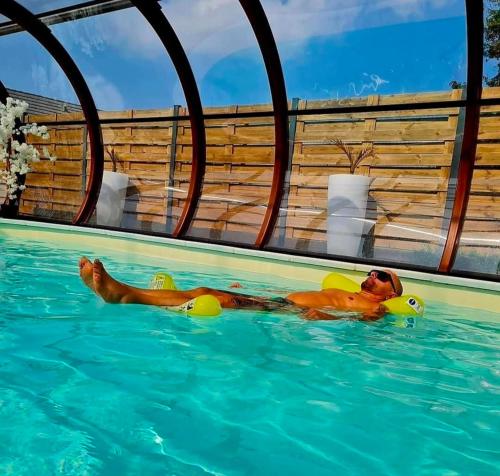 a man in a swimming pool in a swimming pool at A Loffre Zen in Loffre