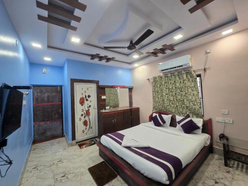 a bedroom with a bed and a tv in it at JBL Beach Resort Mandarmoni in Mandarmoni