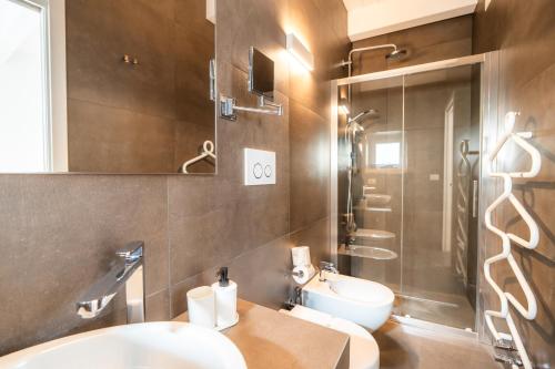 a bathroom with a sink and a toilet and a shower at Iulius Suite in Conversano