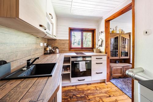 a kitchen with a sink and a counter top at Cottage kingfisher 