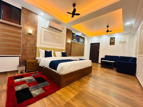 a hotel room with a bed and a couch and a bed and a room at Odyssey Rendezvous in Chottanikara