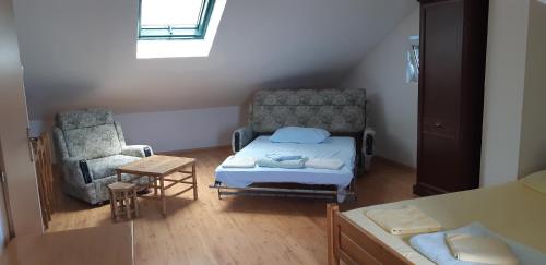 a small room with a bed and a chair at Amore apartments in Budva