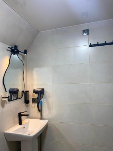 a bathroom with a sink and a shower at Keda Horizon Cottage in Koromkhet'i