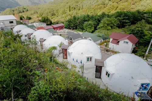 an aerial view of a bunch of domes at Jeongsun Hayandom Pension in Jeongseon