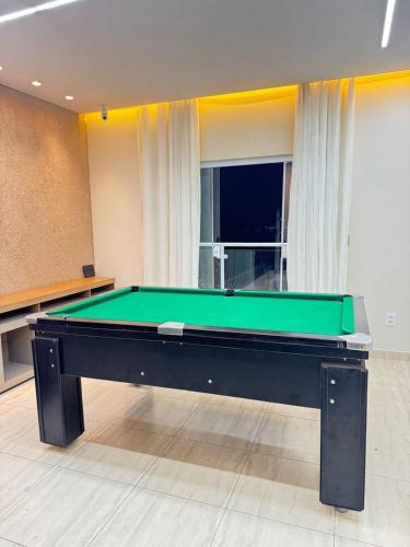 a pool table in a living room with at Área de Lazer in Limeira